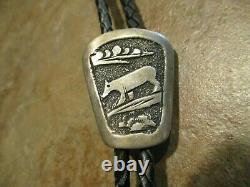 Royaume Tommy (d.) Navajo Sterling Silver Wolf Storyteller Bolo Tie