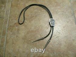 Royaume Tommy (d.) Navajo Sterling Silver Wolf Storyteller Bolo Tie